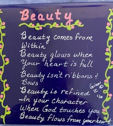 A blue plaque with a poem about Beauty.